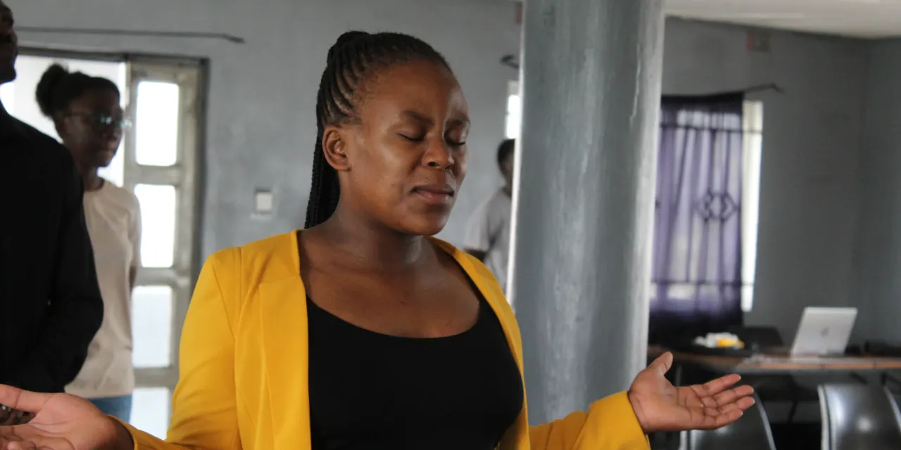 A woman worships with open hands during a Sunday service